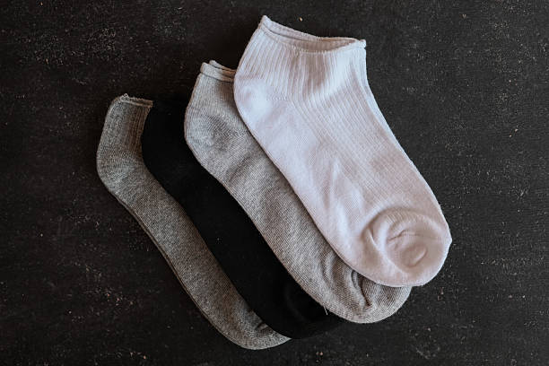 istock Four pairs of colorful ankle socks arranged on a dark textured surface. 2236954027