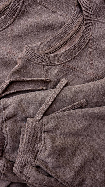 Close-up of a brown sweatshirt with drawstring details.