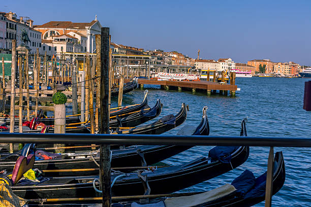Vence, Italy - February 3, 2018: Many Wooden Stakes Mooring for Gondola Boats With Rain Cover at Grand Canal Winter Day Travel.