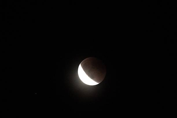 istock A close-up view of a partial lunar eclipse against the dark night sky. 2236957521