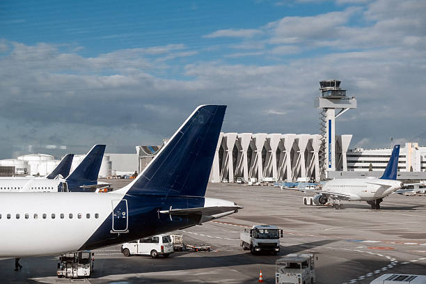 istock Airplanes parked at an airport terminal with control tower 2236958813