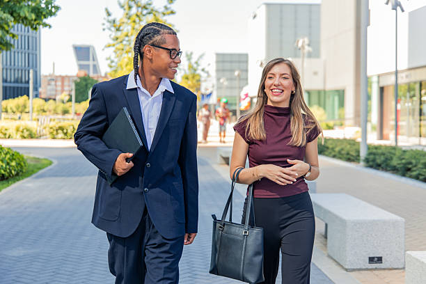 istock Multiethnic business partners walking and talking in financial district 2236960055
