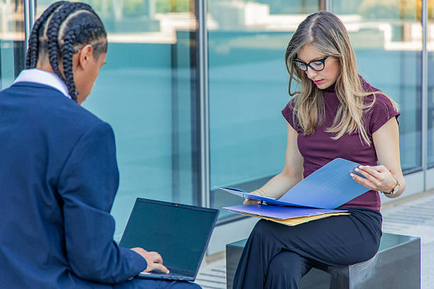 istock Business partners collaborating in urban financial district 2236960146