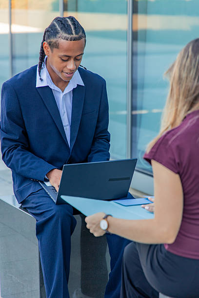 istock Business professionals collaborating outdoors in financial district 2236960148