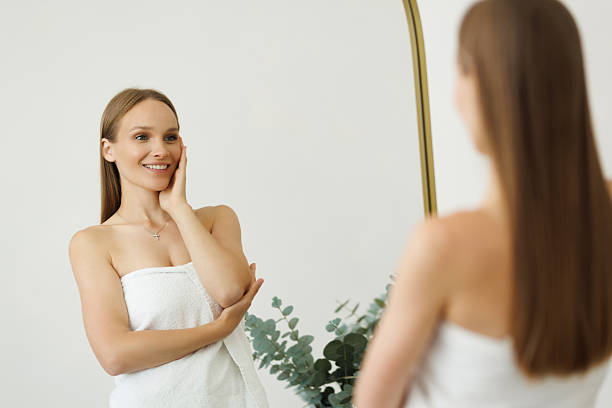 istock Young Woman looking on reflection in the mirror after shower 2236960692