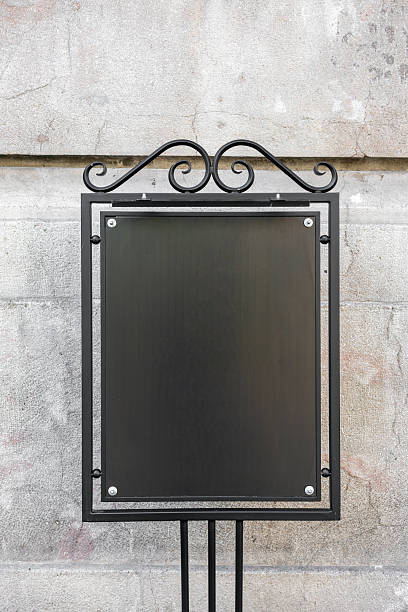 istock Empty urban black metal sign on stone wall. Concept shows communication, information, message, presentation, space, and the universal language of signage in public environments. Copy empty space 2236962662