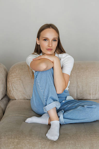 istock Smiling womsn relax sit on sofa at home 2236963881