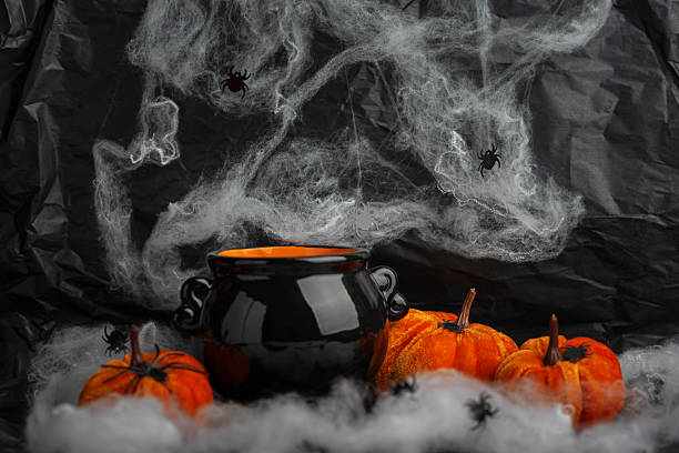istock Halloween Cauldron with Pumpkins, Spiders and Cobwebs 2236964434