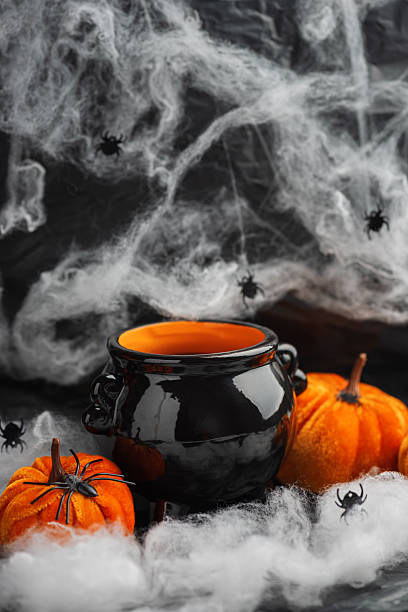 istock Halloween Cauldron with Pumpkins, Spiders and Cobwebs 2236964435