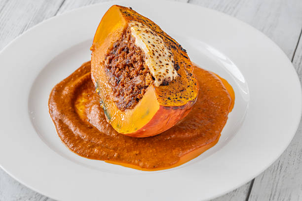 Portion of baked Hokkaido pumpkin with beef, tomato sauce, mozzarella cheese
