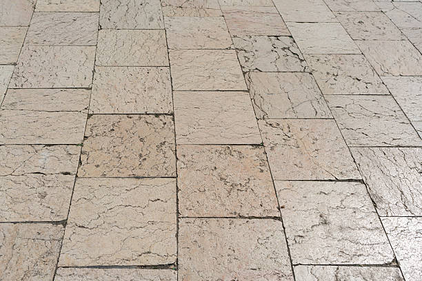 Beige stone or tiles road, a beautiful background for the designer with empty space