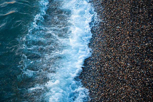 Small pebbles on the seashore. Pebble sea beach.