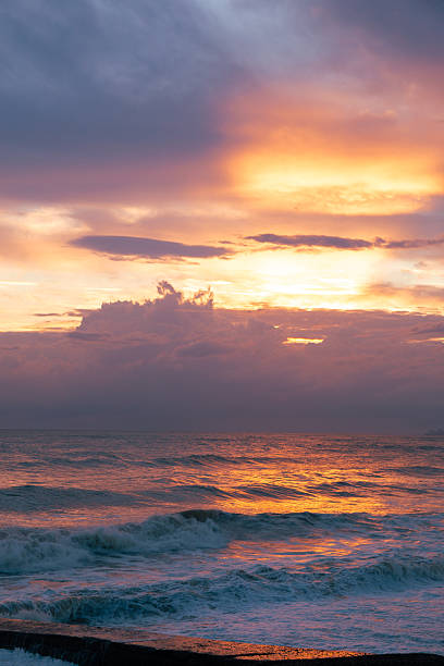 istock Beautiful pink sunset and clouds over the ocean. Delicate peach sunset background 2236974064