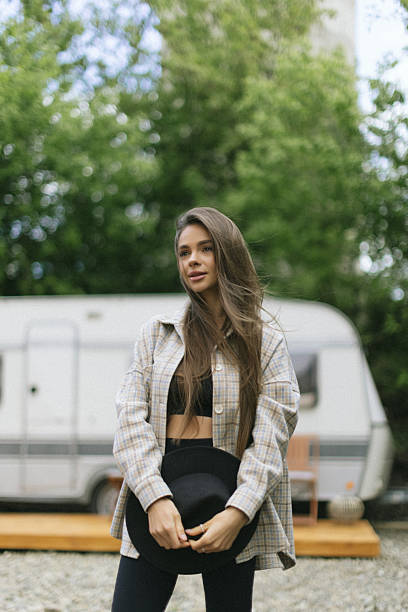 istock Happy woman standing near camper van 2236976607
