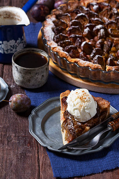 istock German plum cake with cinnamon, served with ice cream and coffee. 2236977122