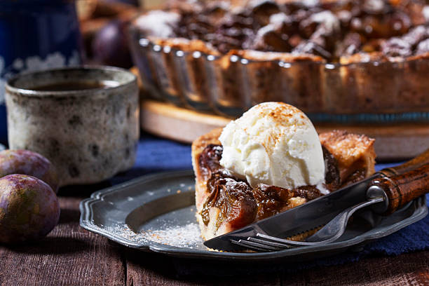istock German plum cake with cinnamon, served with ice cream and coffee. 2236977123