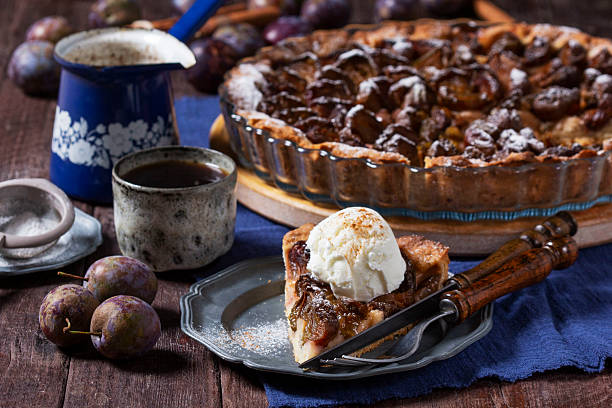 istock German plum cake with cinnamon, served with ice cream and coffee. 2236977131