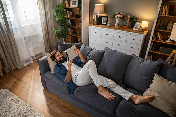 istock Young man relaxing on sofa making video call 2236978745