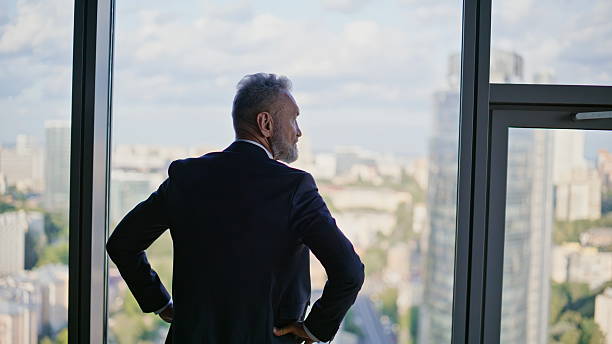 istock Successful leader standing panoramic window looking beautiful city closeup. 2236979848