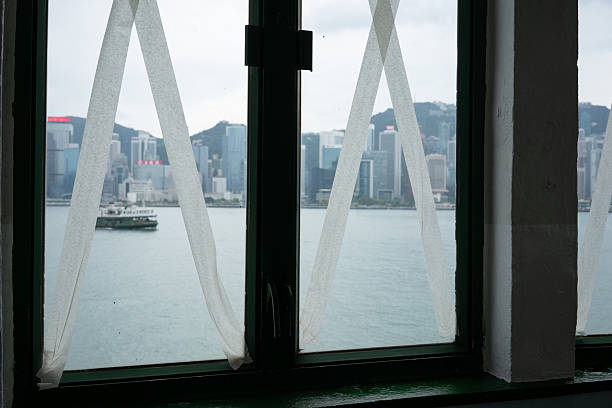 Hong Kong, China - September 23, 2025: Windows secured with crisscrossed tape stand as a protective measure against the approaching Super Typhoon Ragasa.