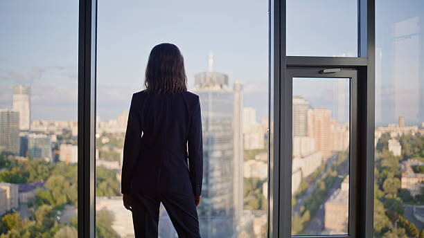 istock Successful manager contemplating cityscape from office panoramic window. 2236983866