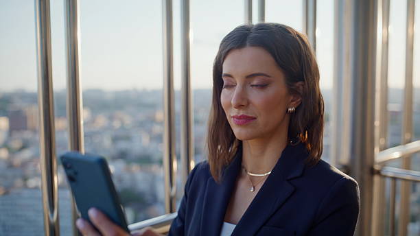 istock Closeup brunette browsing mobile phone banking app standing office balcony. 2236984855