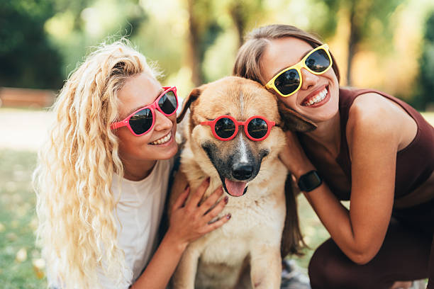istock Best friends having fun with their cool dog 2236985832