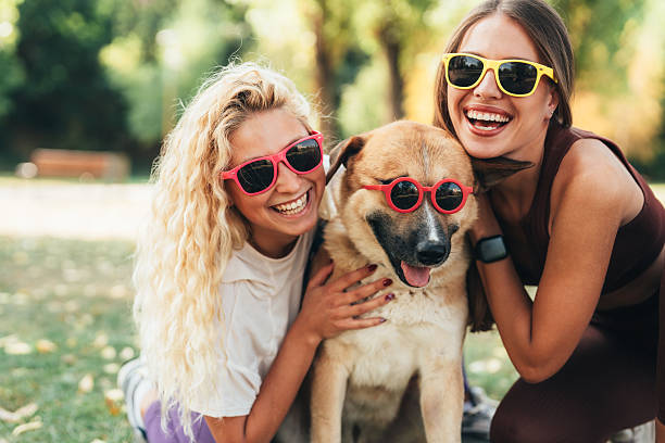 istock Best friends having fun with their cool dog 2236985833