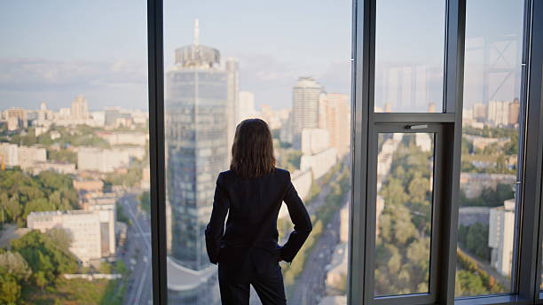istock Back executive enjoying city view from office panoramic window. Successful woman 2236990185