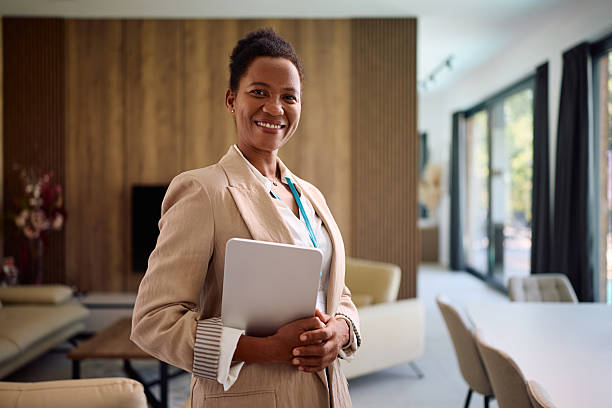 istock Happy black female real estate agent looking at camera. 2236990295