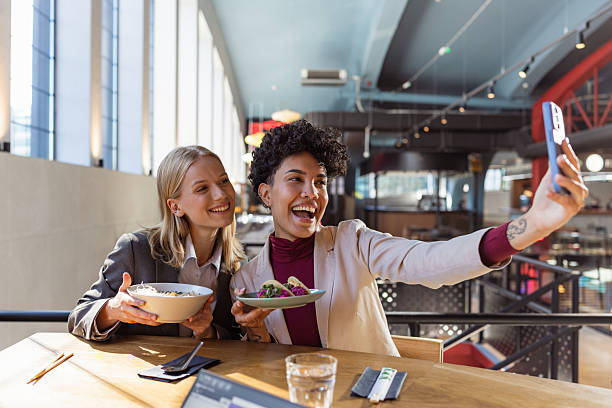 istock Two businesswomen doing a selfie while sharing a lunch break 2236991309