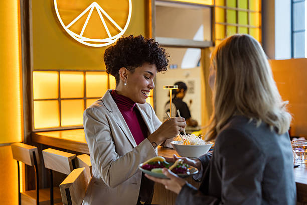 istock Two businesswomen share a lunch break at a restaurant 2236991352