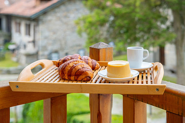 breakfast with creamy pudding panna cotta, fresh croissants, and coffee, Italian Morning, rustic village from balcony, Authentic Italian Charm