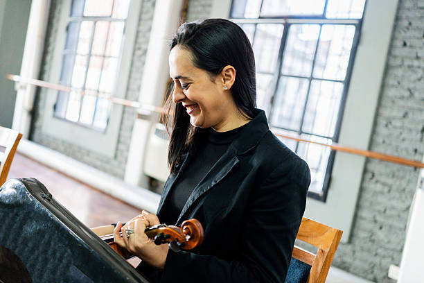 Musician opening violin bag on a music studio