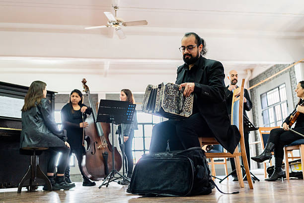 Musician playing accordion on a music studio