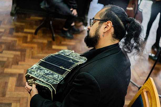 Musician playing accordion on a music studio