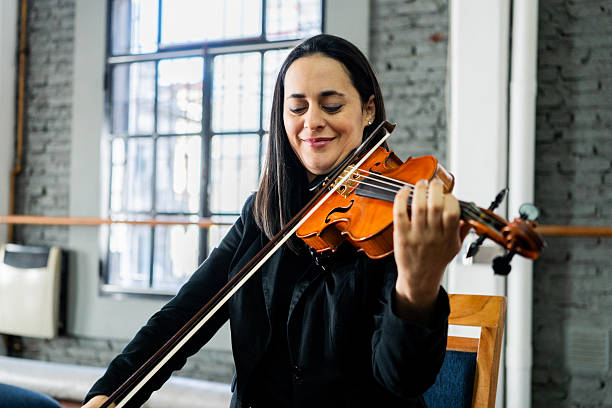 istock Musician playing violin on a music studio 2236994455