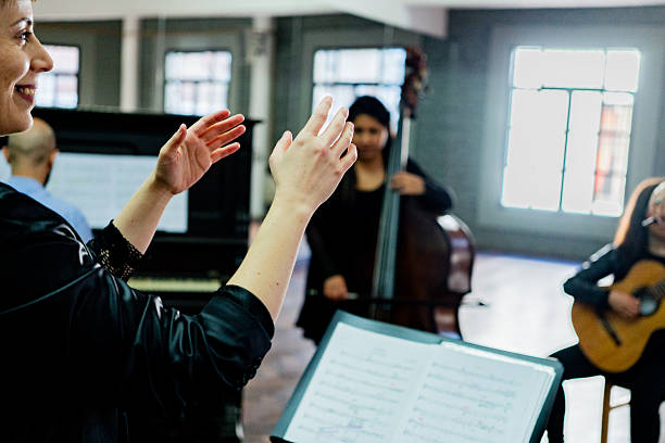 Musical conductor conducting orchestra on a music studio