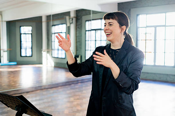 Musical conductor conducting orchestra on a music studio