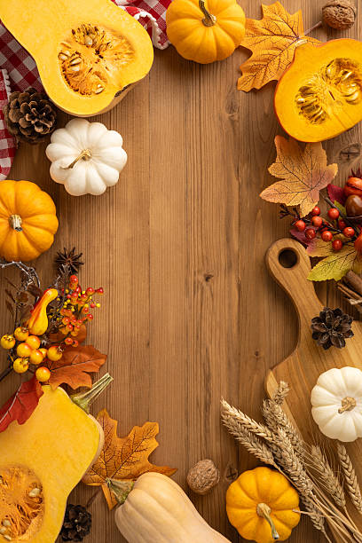 istock Vertical view emphasizing the Thanksgiving celebration featuring pumpkins, autumn leaves, and harvest on a wooden background 2236996064