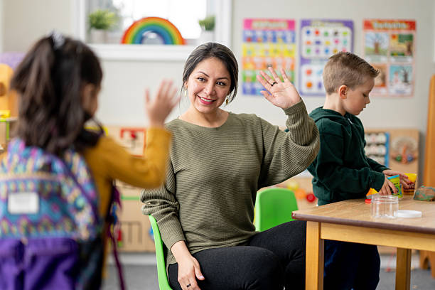 istock Friendly Hispanic Woman Teacher High-Fiving Students In Classroom During Learning Activity 2236996138