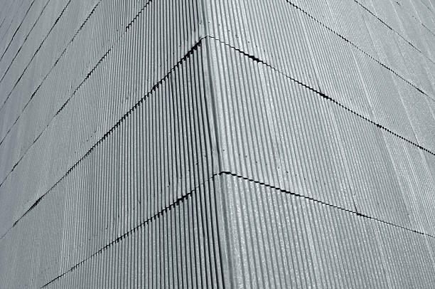 A close-up photograph of the corner of a corrugated sheet metal building facade