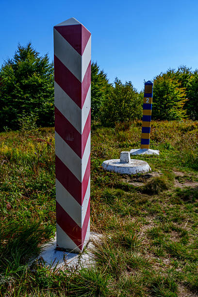 istock Polish and Ukrainian border posts on sunlit meadow beneath blue sky 2236998133