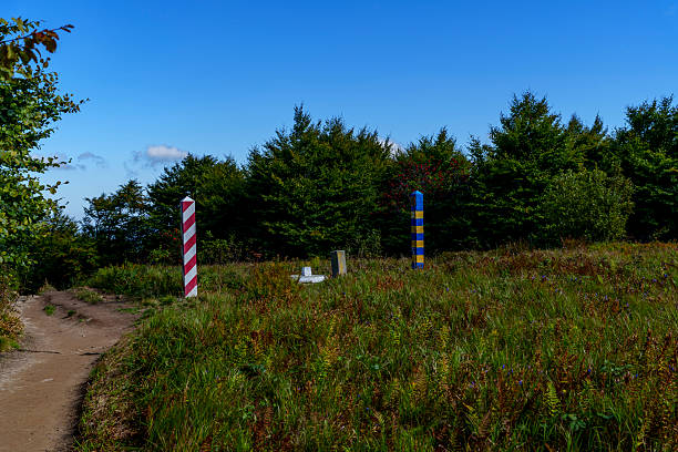 istock Sunny border meadow with Poland and Ukraine posts beneath blue sky 2236998143