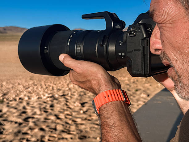 istock Photographer capturing an image using a long zoom lens 2237000025