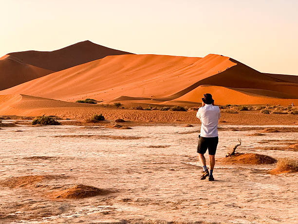 istock Photographer discovering Sossusvlei in Namib desert 2237000055