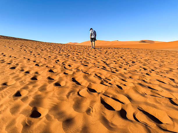 istock Photographer discovering Sossusvlei in Namib desert 2237000075