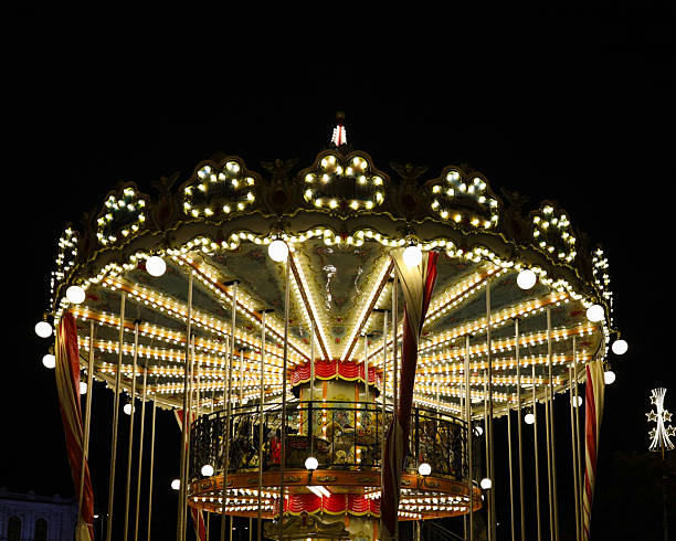 Children's carousel at night with lights on