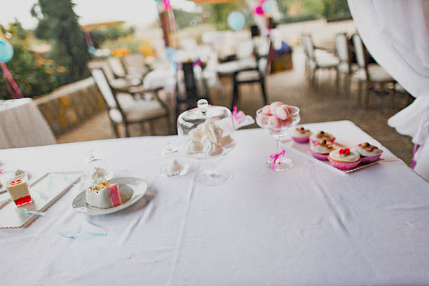 A beautifully arranged dessert table featuring an array of colorful cupcakes and sweets, perfect for any festive occasion.