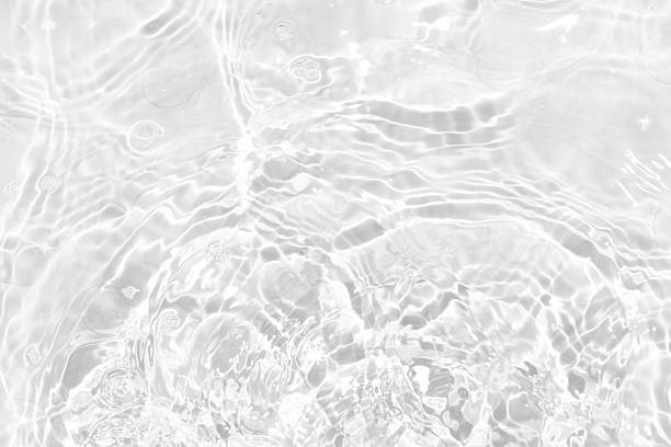 istock White water with ripples on the surface. Defocus blurred transparent white colored clear calm water surface texture with splashes and bubbles. Water waves with shining pattern texture background. 2237010101